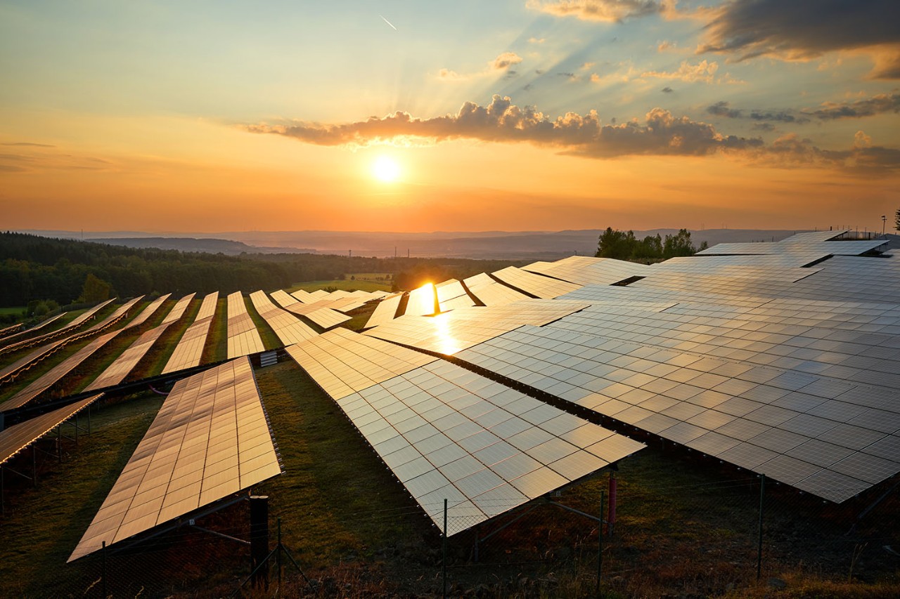 Photovoltaic panels of solar power station in the landscape at sunset. View from above. Photovoltaic panels of solar power station in the landscape at sunset. View from above.